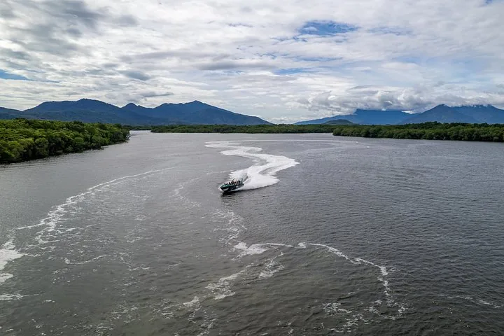 Jetboat leaving a long white wake on the wide Trinity Inlet